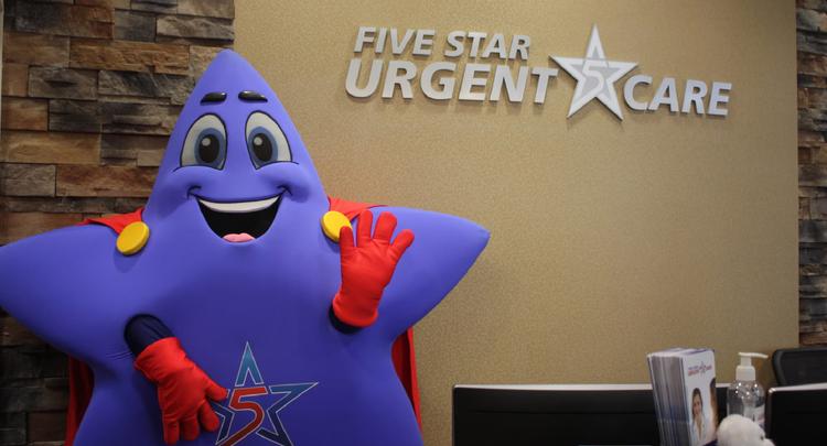 Photo of Five Star Urgent Care mascot waving in front of the office