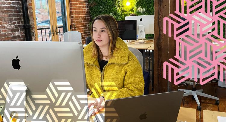 women sitting at mac computer