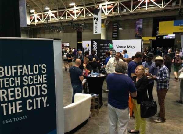 Tradeshow photo with booths and people talking
