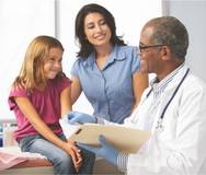 photo of doctor with child and mother