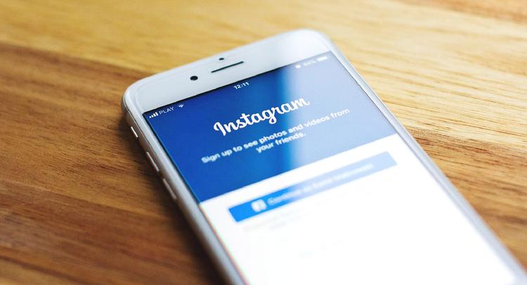 Smart phone on table with Instagram on screen