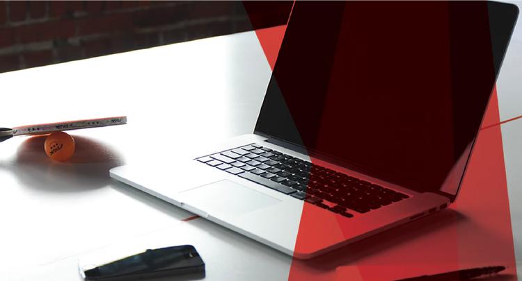 Screenshot of an Apple laptop next to a ping pong paddle and ball