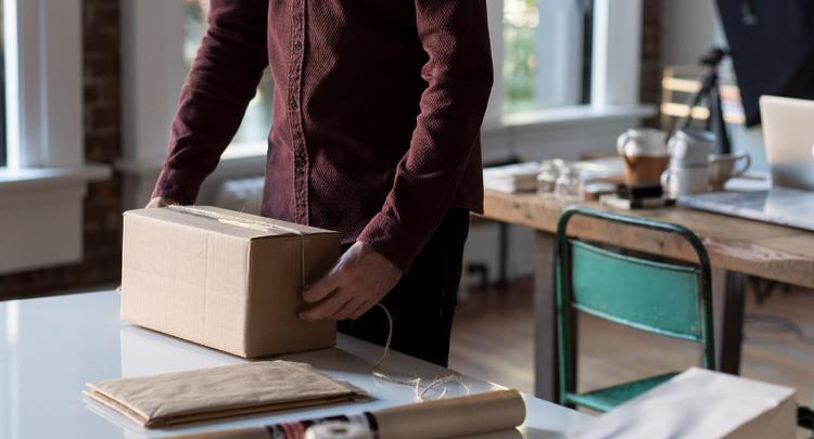 photo of man tying string around package