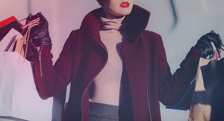 photo of woman carrying shopping bags