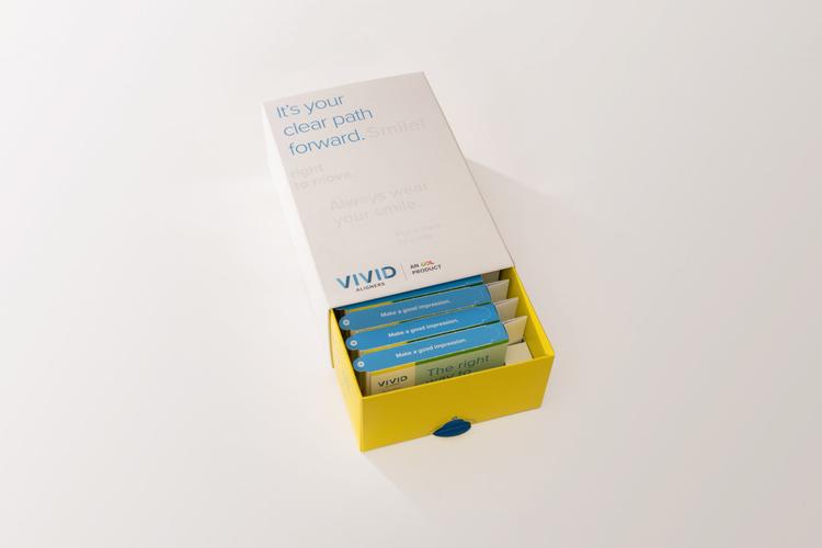 Vivid Aligner packaging - the inner tray of the box has been slid out of the sleeve, revealing a row of blue individual aligner boxes